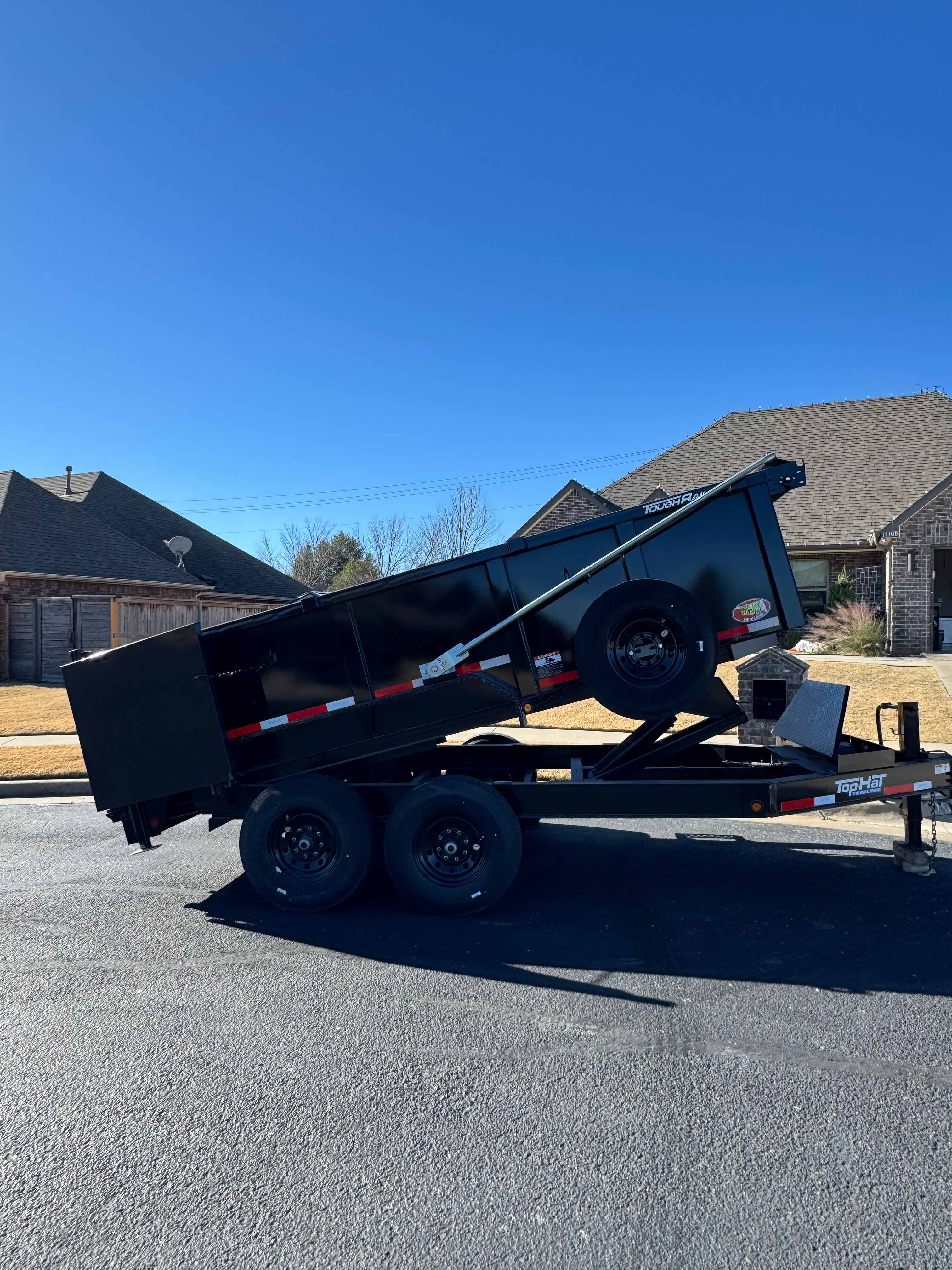 14 foot dump trailer detail showing steel ramps and D-rings